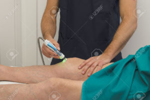 23885179-Laser-therapy-on-a-knee-Stock-Photo